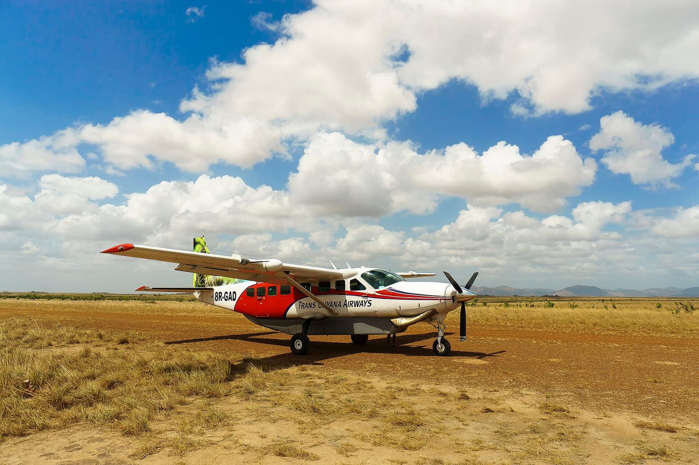 A Cessna Caravan of Trans Guyana Airways parked on a grass airstrip in the Rupununi