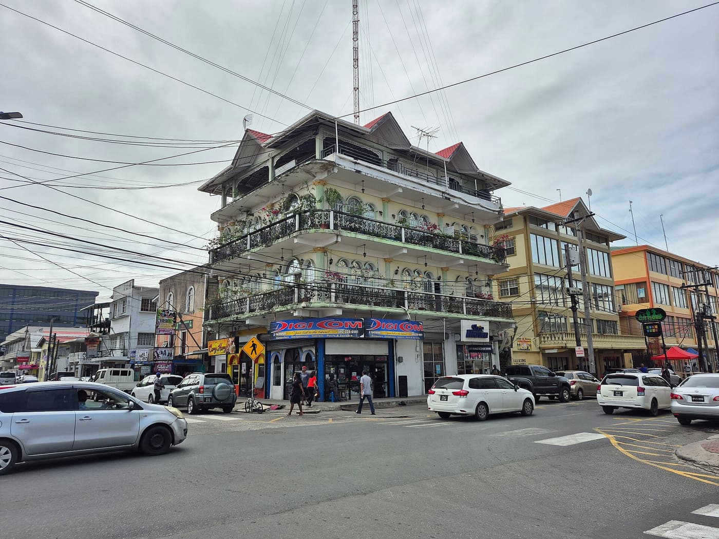 A street corner in central Georgetown with an ornate building ringed by balconies