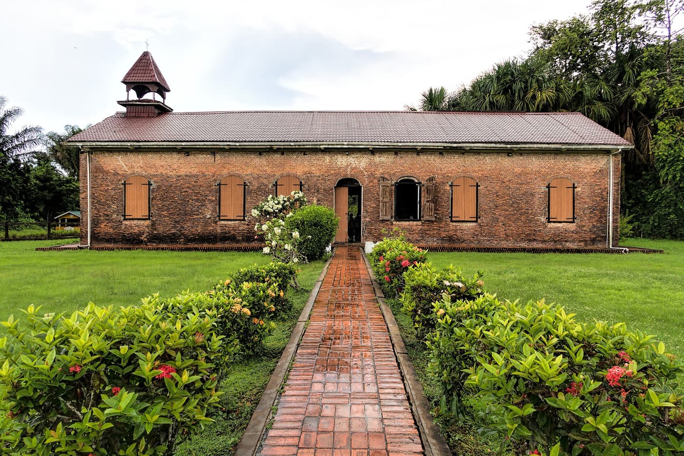 The restored brick Court of Policy building on Fort Island, at the end of a garden path
