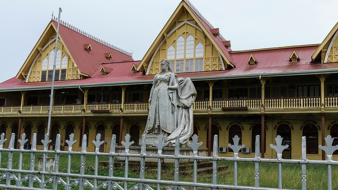 The High Court building with its statue of Queen Victoria behind white railings