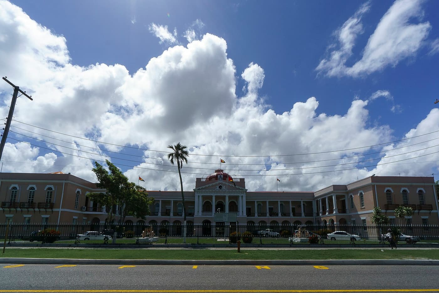 The long colonnaded Parliament Building seen across a street
