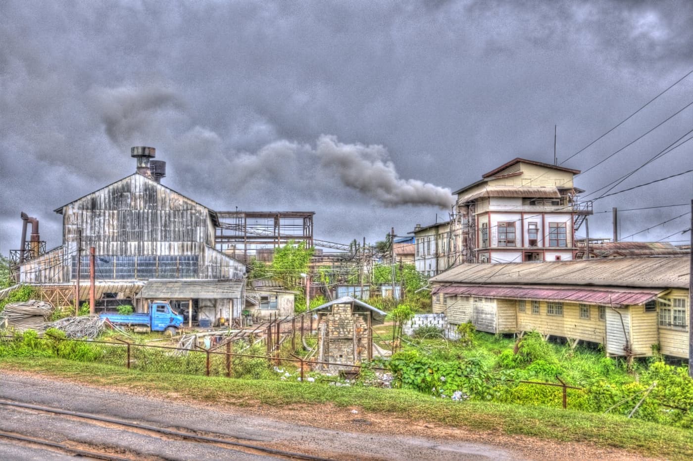 The ageing bauxite processing plant at Linden with smoke rising from a chimney